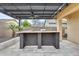 Outdoor kitchen with countertop bar and pergola offering a backyard entertaining space at 18256 W Carol Ave, Waddell, AZ 85355