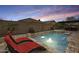 Backyard pool with a lounge area and a built-in hot tub at 18256 W Carol Ave, Waddell, AZ 85355