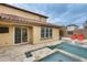 Backyard view with a sparkling pool and deck, blending indoor and outdoor living at 18256 W Carol Ave, Waddell, AZ 85355