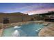 Backyard with an inviting pool, complete with a spa and outdoor entertaining spaces at 18256 W Carol Ave, Waddell, AZ 85355