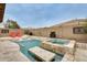 Inviting backyard pool and spa area, complete with lounge chairs and travertine tile decking at 18256 W Carol Ave, Waddell, AZ 85355