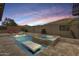 Luxurious pool and spa area with water features and lounge chairs at 18256 W Carol Ave, Waddell, AZ 85355