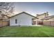 This backyard features a small seating area, artificial turf lawn, and mature landscaping at 18359 N 88Th Ave, Peoria, AZ 85382