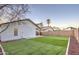 Spacious backyard featuring a well-maintained artificial lawn and block wall, providing privacy and a low-maintenance outdoor space at 18359 N 88Th Ave, Peoria, AZ 85382