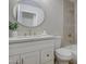 Bright bathroom featuring a white vanity, gold fixtures, round mirror, and tiled shower/tub combo at 18359 N 88Th Ave, Peoria, AZ 85382