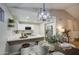 Dining area with modern chandelier, set table, and open view into updated kitchen at 18359 N 88Th Ave, Peoria, AZ 85382