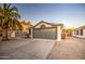 Single-story home with gray garage door, desert landscaping, and mature palm tree at 18359 N 88Th Ave, Peoria, AZ 85382