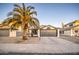 Single-story home with gray garage door, desert landscaping, and mature palm tree at 18359 N 88Th Ave, Peoria, AZ 85382