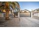 Single-story home with gray garage door, desert landscaping, and mature palm tree at 18359 N 88Th Ave, Peoria, AZ 85382