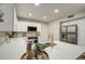 Bright modern kitchen with white cabinets, quartz countertops, and stainless steel appliances at 18359 N 88Th Ave, Peoria, AZ 85382