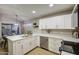 Bright, spacious kitchen with white cabinets, stainless steel appliances, and an adjacent dining area at 18359 N 88Th Ave, Peoria, AZ 85382