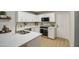 Well-lit kitchen featuring white cabinets, stainless steel appliances, and a stylish countertop at 18359 N 88Th Ave, Peoria, AZ 85382