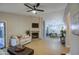 Open living room with fireplace, neutral decor, and view of dining area at 18359 N 88Th Ave, Peoria, AZ 85382