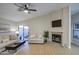 Inviting living room with fireplace, sliding glass doors, and comfortable seating at 18359 N 88Th Ave, Peoria, AZ 85382