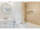 Stylish bathroom featuring neutral tile shower, modern vanity, and decorative mirror at 1841 N Wilbur Cir, Mesa, AZ 85201