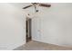 Bright bedroom with a ceiling fan and a white door leading into an adjacent bathroom at 1841 N Wilbur Cir, Mesa, AZ 85201