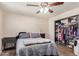 Bedroom with furnishings, carpet, a ceiling fan, and an open closet filled with clothes at 1841 N Wilbur Cir, Mesa, AZ 85201