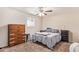 Bedroom with furnishings, carpet, and a ceiling fan, exuding a comfortable and inviting atmosphere at 1841 N Wilbur Cir, Mesa, AZ 85201