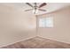 Bedroom featuring neutral walls, plush carpet, a ceiling fan, and a window with blinds at 1841 N Wilbur Cir, Mesa, AZ 85201