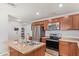 Bright kitchen featuring stainless appliances, wood cabinets, and an island with a sink at 1841 N Wilbur Cir, Mesa, AZ 85201