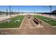 Outdoor cornhole area with benches, artificial turf, and playing lanes at 18763 N Avelino Dr, Maricopa, AZ 85138