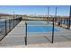 Outdoor pickleball courts enclosed with black fencing and blue court surface at 18763 N Avelino Dr, Maricopa, AZ 85138