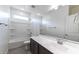 Bright bathroom featuring a white vanity top, tub with shower, and gray tile flooring at 18783 N Avelino Dr, Maricopa, AZ 85138