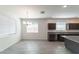 Bright dining area with tile flooring, modern chandelier, and natural light at 18783 N Avelino Dr, Maricopa, AZ 85138