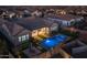 Beautiful backyard aerial view with a pool, spa, and landscaped yard at dusk at 1899 E Everglade Ln, Gilbert, AZ 85298