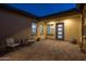 Cozy back patio with neutral-colored pavers, comfortable seating, and a view of the home's exterior at 1899 E Everglade Ln, Gilbert, AZ 85298