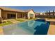 Backyard features a stunning pool and spa, artificial turf, and a covered patio at 1899 E Everglade Ln, Gilbert, AZ 85298