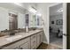 Bathroom with double sinks, wood-look tile floors and white door at 1899 E Everglade Ln, Gilbert, AZ 85298