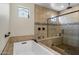 Bright bathroom featuring soaking tub, glass enclosed shower and neutral tile at 1899 E Everglade Ln, Gilbert, AZ 85298