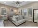 Comfortable bedroom features neutral carpet, ceiling fan and plenty of natural light at 1899 E Everglade Ln, Gilbert, AZ 85298