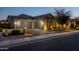 Attached two-car garage with brick-paved driveway, accent lighting, and manicured landscaping at 1899 E Everglade Ln, Gilbert, AZ 85298