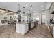 Open kitchen featuring an oversized center island with seating and designer pendant lighting at 1899 E Everglade Ln, Gilbert, AZ 85298