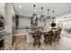 Modern kitchen with a large island, decorative pendant lights, and stainless steel appliances at 1899 E Everglade Ln, Gilbert, AZ 85298