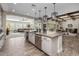 Elegant kitchen featuring a central island, stainless steel appliances, and easy access to the living area at 1899 E Everglade Ln, Gilbert, AZ 85298