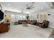 Spacious living room with neutral carpet, plantation shutters and comfortable brown sectional sofa at 1899 E Everglade Ln, Gilbert, AZ 85298