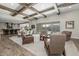 Spacious living room featuring wood floors, beamed ceilings, and seamless flow to the outdoor patio at 1899 E Everglade Ln, Gilbert, AZ 85298