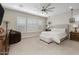 Comfortable main bedroom featuring neutral carpet, ceiling fan and cushioned headboard at 1899 E Everglade Ln, Gilbert, AZ 85298