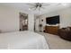 Tranquil main bedroom featuring plush carpet, ceiling fan and Primary bathroom access at 1899 E Everglade Ln, Gilbert, AZ 85298