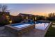 Beautiful pool and spa with lighting, water features, and lush landscaping at 1899 E Everglade Ln, Gilbert, AZ 85298