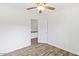 Bedroom features wood floors, white trim, a ceiling fan and closet at 1911 E Hartford Ave, Phoenix, AZ 85022