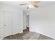 Bright bedroom with vinyl floors, white walls, and a ceiling fan at 1911 E Hartford Ave, Phoenix, AZ 85022