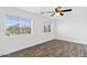 Bedroom showcasing wood-style flooring and natural light from two windows at 1911 E Hartford Ave, Phoenix, AZ 85022