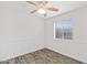 Comfortable bedroom featuring a window, ceiling fan, and vinyl wood-look flooring at 1911 E Hartford Ave, Phoenix, AZ 85022