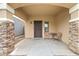 Covered entryway and patio features stone columns and neutral paint at 1911 E Hartford Ave, Phoenix, AZ 85022