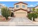 Two-story home featuring tan stucco, brown trim and stone accents around the garage with mature landscaping at 1911 E Hartford Ave, Phoenix, AZ 85022