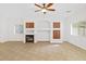 Spacious living room with fireplace, built-ins and large windows for natural light at 1911 E Hartford Ave, Phoenix, AZ 85022